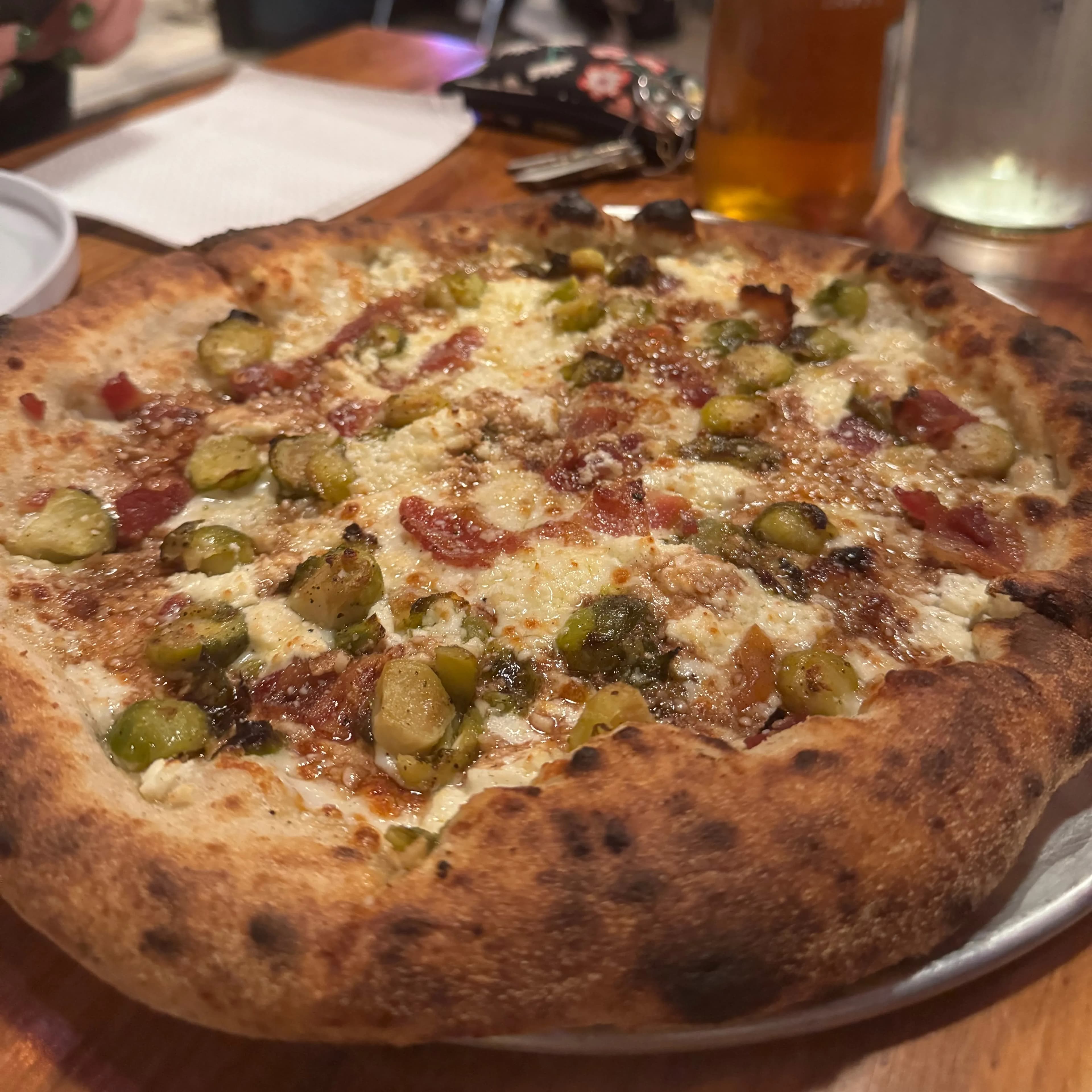 olive oil, diced mozzarella, goat cheese, shaved brussels, bacon, honey balsamic glaze