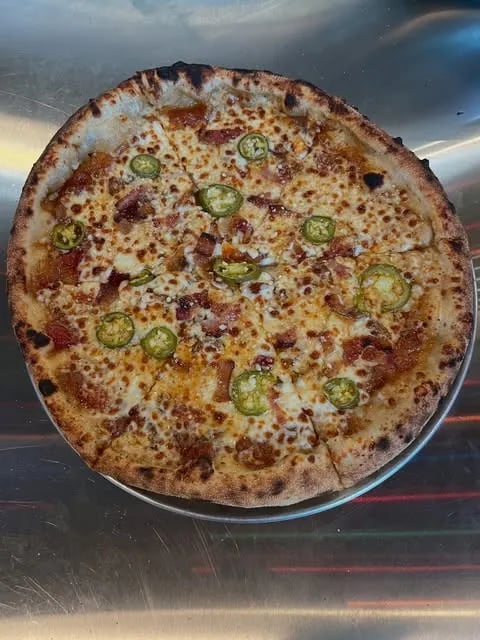 Vidalia onion-tomato jam, mozzarella, house pickled jalapeños, bacon.