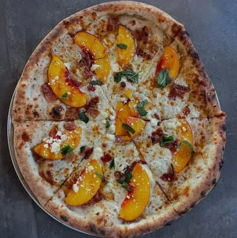 Olive oil, feta, mozzarella, @pearsonfarmga peaches, bacon, mint, spicy cane syrup.
