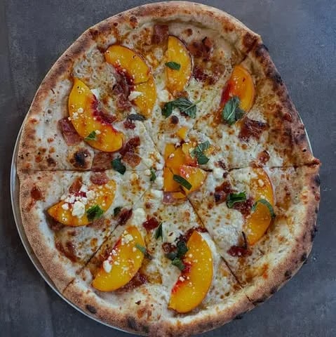 Olive oil, feta, mozzarella, @pearsonfarmga peaches, bacon, mint, spicy cane syrup.