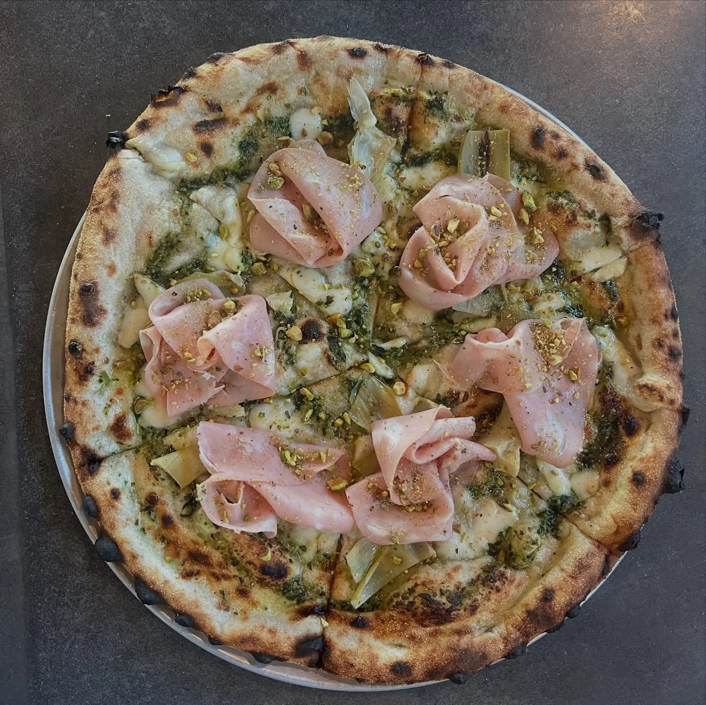 House pesto made with @pearsonfarmga pecans, mozzarella, marinated artichoke, mortadella, pistachio.
