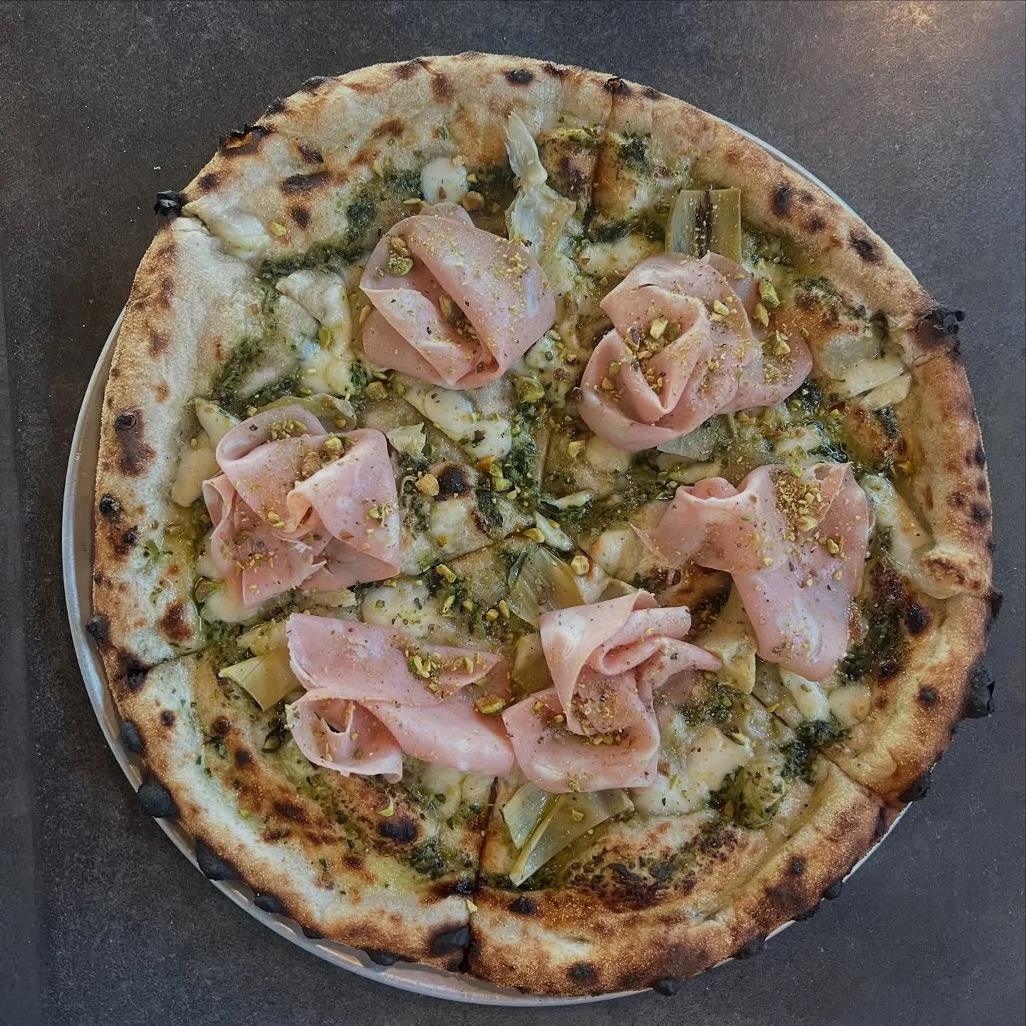 House pesto made with @pearsonfarmga pecans, mozzarella, marinated artichoke, mortadella, pistachio.