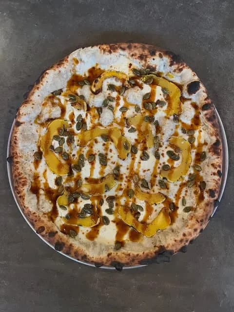 Hmmm maybe do like a béchamel sauce with delicata squash, mozzarella and ricotta cheese, some roasted pepitas, and a spicy cane syrup drizzle.