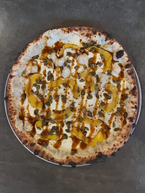 Hmmm maybe do like a béchamel sauce with delicata squash, mozzarella and ricotta cheese, some roasted pepitas, and a spicy cane syrup drizzle.