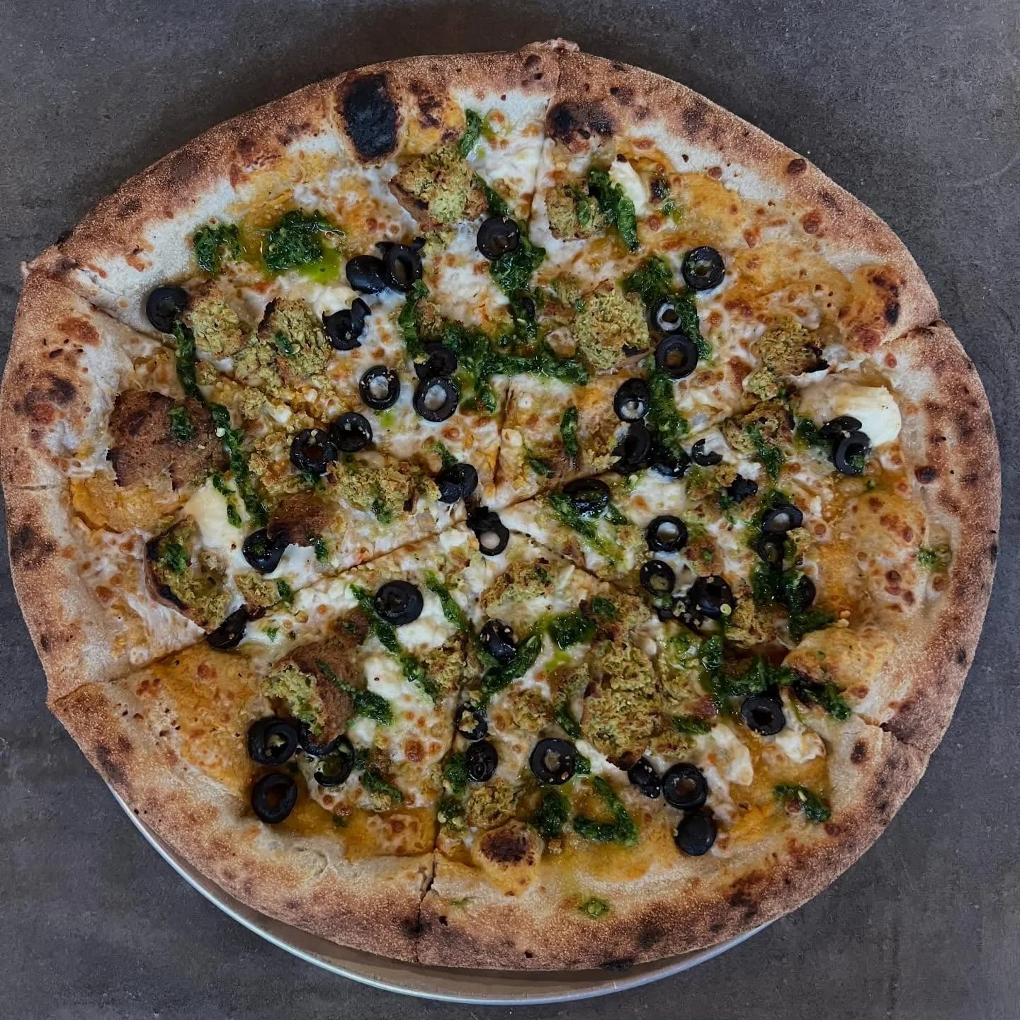 Pretty stoked on this one. Roasted red pepper hummus, feta, mozzarella, falafel, black olives, spicy zhug sauce.