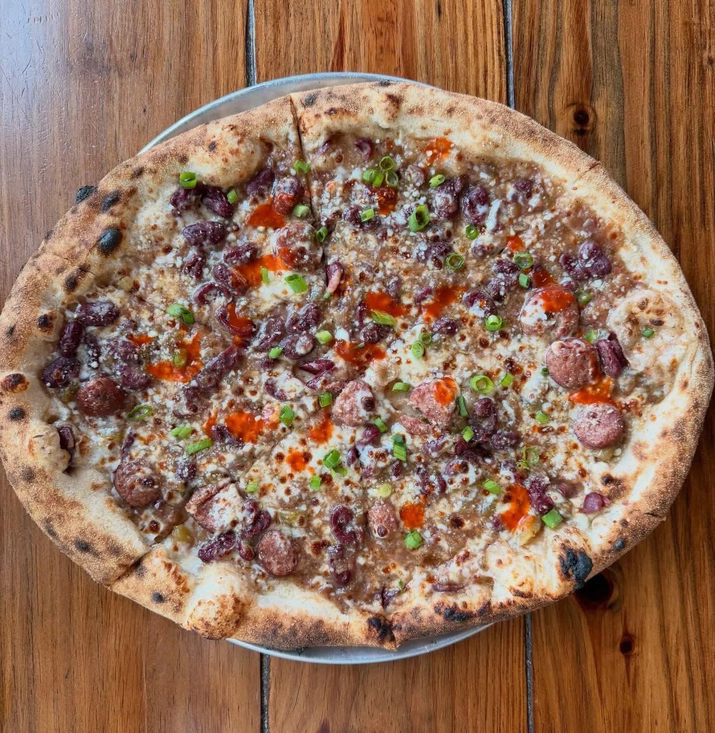 Cajun style red beans with smoked Conecuh sausage, mozzarella, chives, Crystal hot sauce