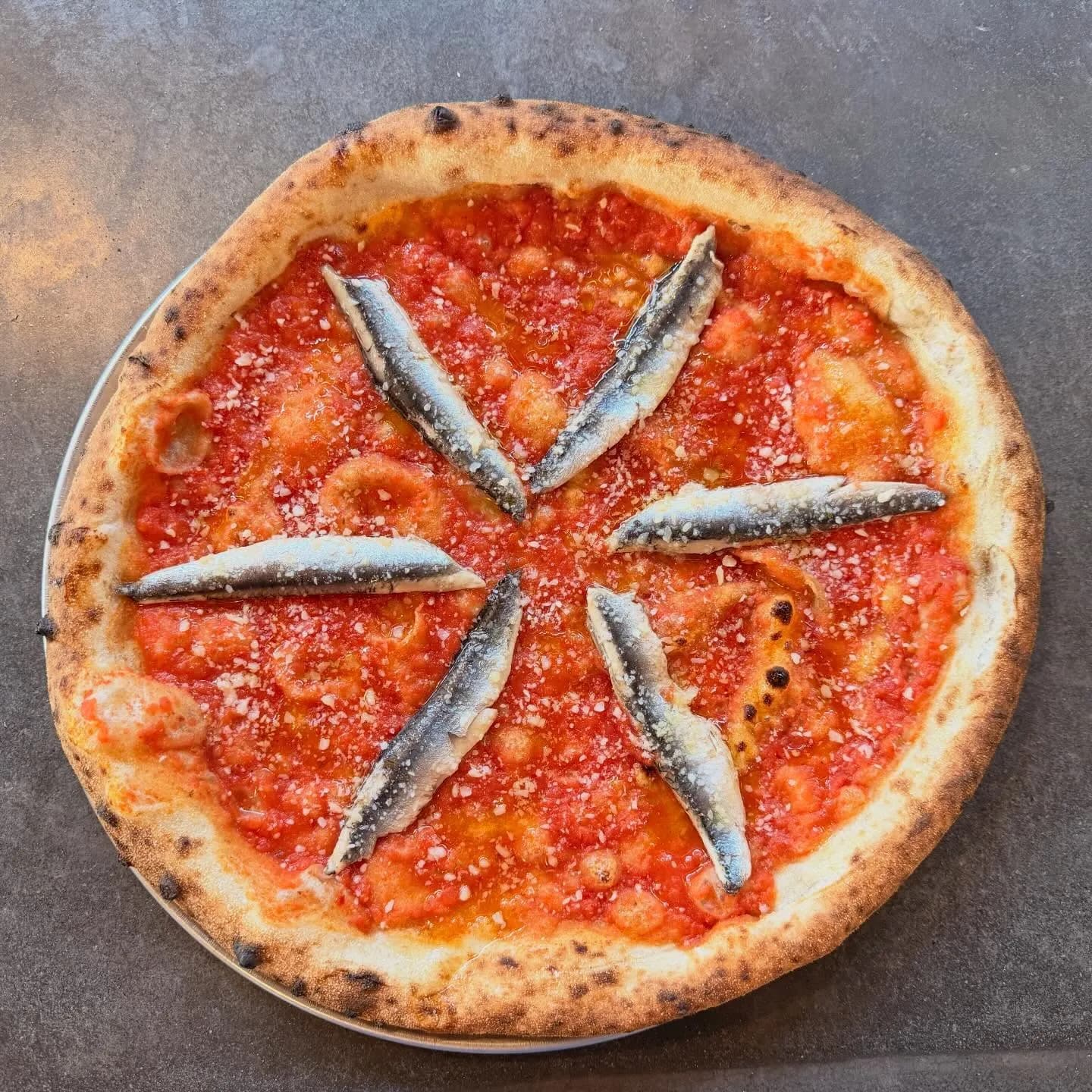 Tomato sauce, anchovy, Parmesan, olive oil.