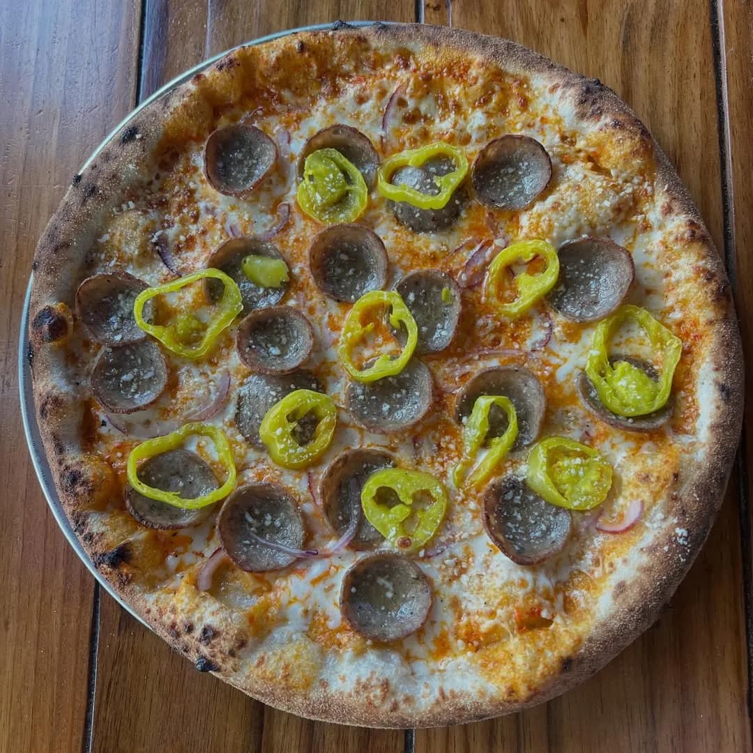 Calabrian chili cream, mozzarella, Italian sausage, banana peppers, red onion.